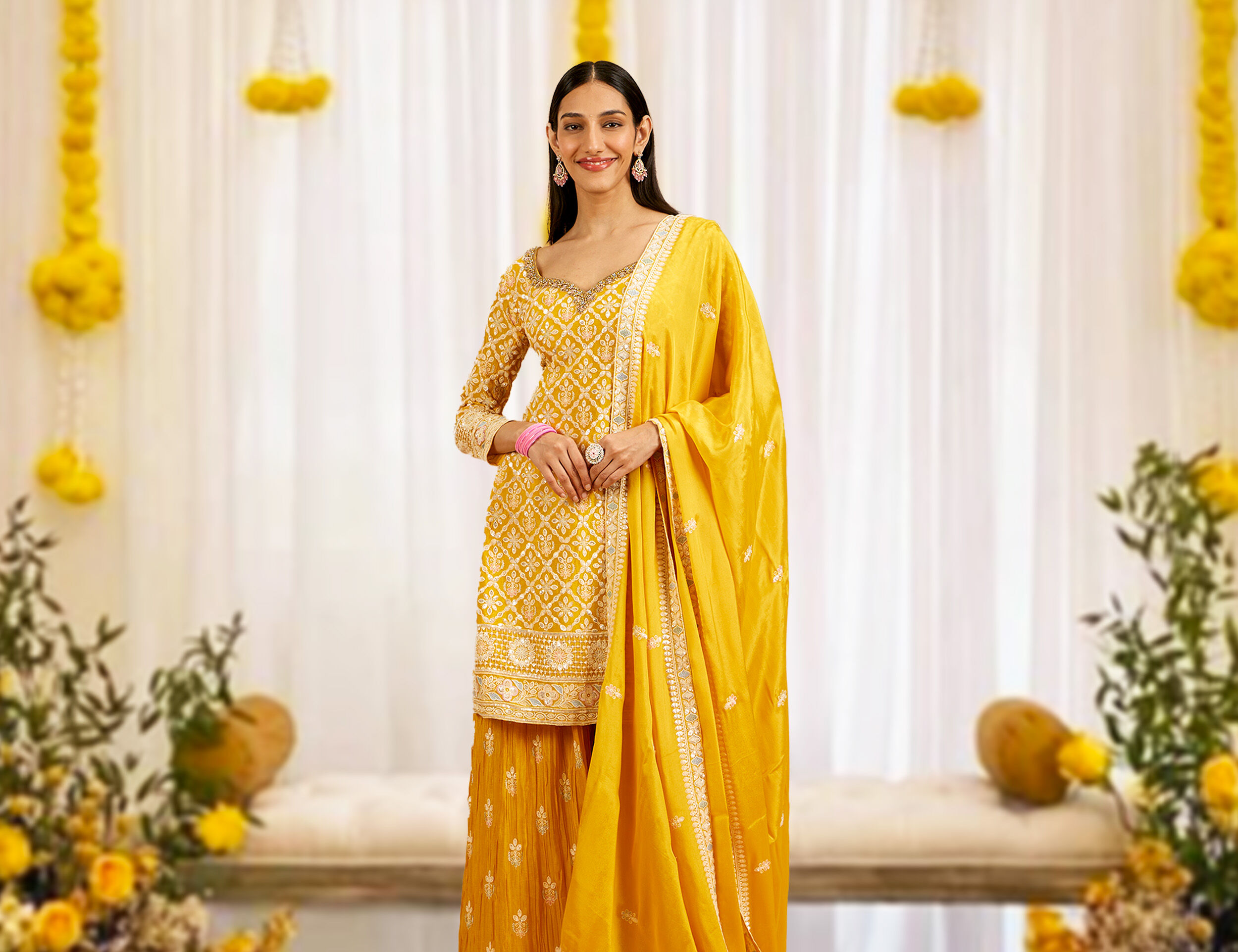 A girl looking stunning in a vibrant yellow lehenga paired with a matching yellow dupatta.